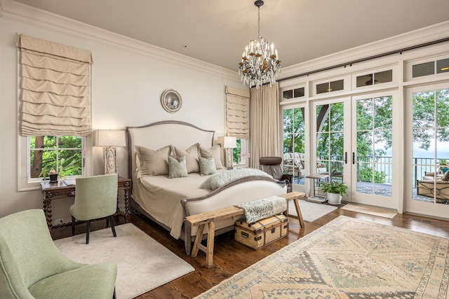 bedroom featuring hardwood / wood-style floors, an inviting chandelier, access to exterior, and ornamental molding