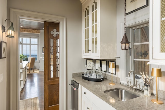 interior space featuring white cabinetry, dark hardwood / wood-style flooring, sink, and light stone countertops