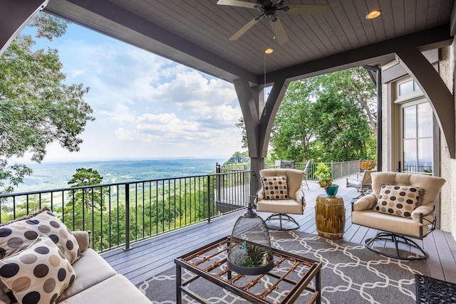 balcony featuring ceiling fan, an outdoor hangout area, and a water view