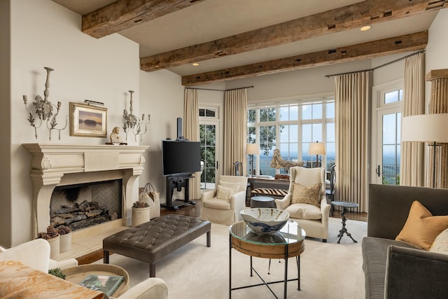 carpeted living room featuring beamed ceiling