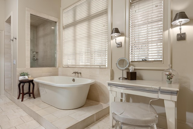 bathroom with independent shower and bath and tile patterned floors