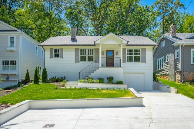 view of front of home featuring a garage and a front yard