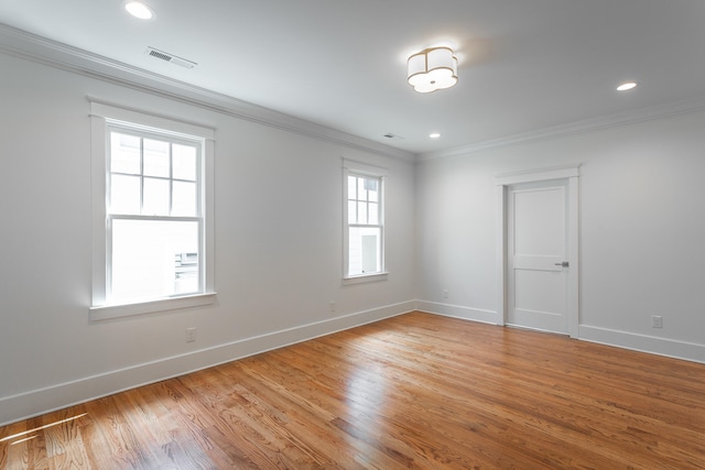 empty room featuring light hardwood / wood-style flooring and ornamental molding