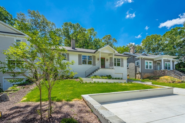 view of front of home with a garage and a front yard