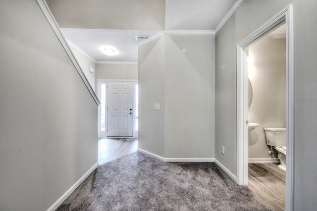 entryway featuring ornamental molding and hardwood / wood-style floors