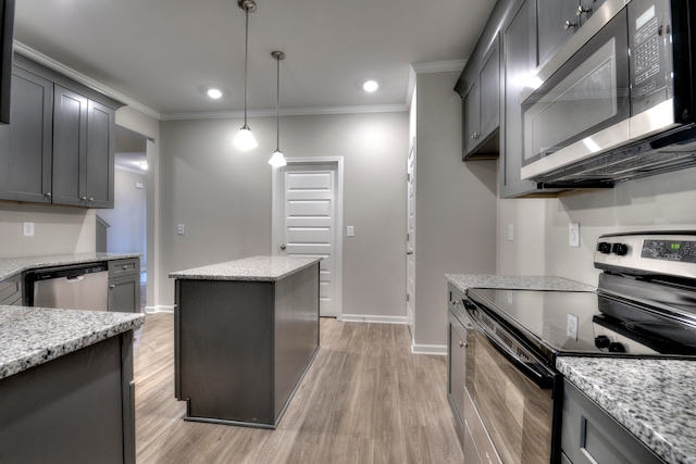 kitchen featuring hanging light fixtures, crown molding, light wood-type flooring, appliances with stainless steel finishes, and light stone countertops