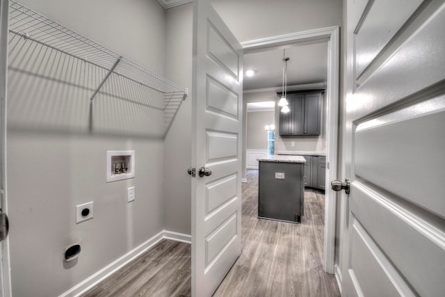 washroom with washer hookup, crown molding, dark hardwood / wood-style floors, and electric dryer hookup