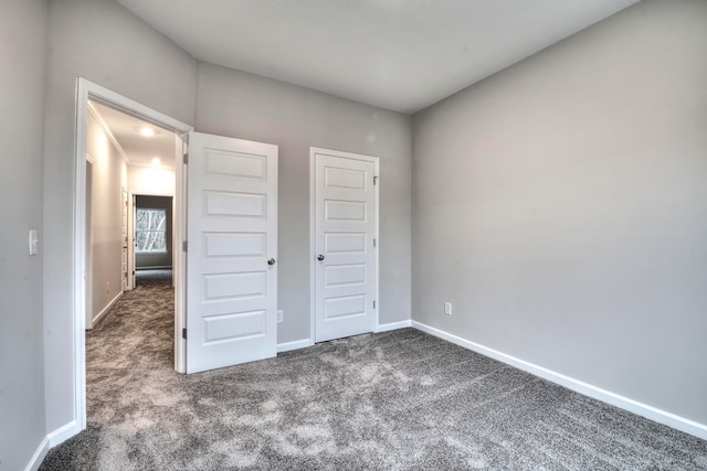 unfurnished bedroom with a closet and carpet floors