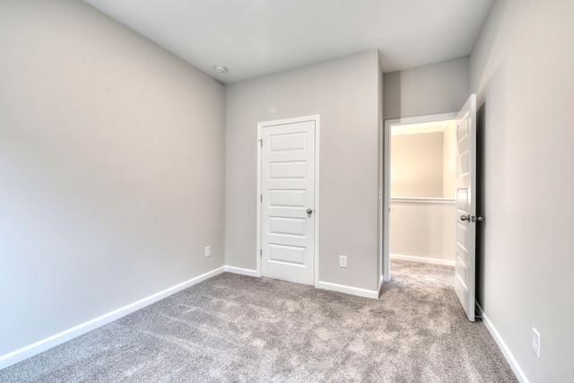 unfurnished bedroom with a closet and carpet