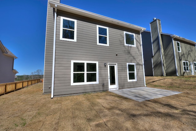 rear view of house featuring a yard and a patio area