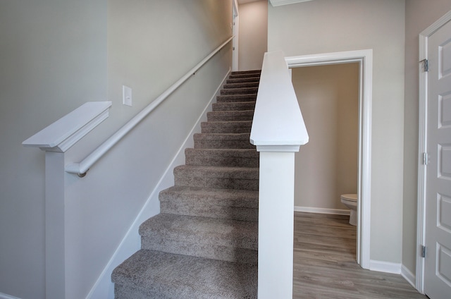 stairs featuring hardwood / wood-style floors