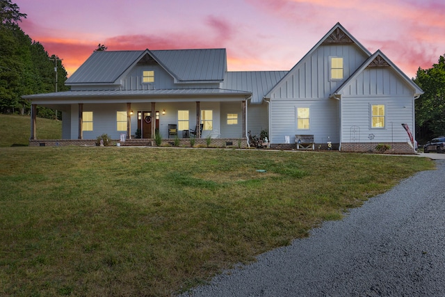 view of front facade featuring a porch and a lawn