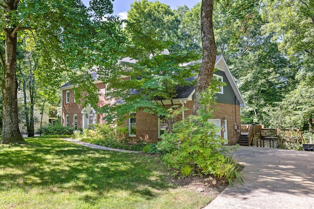 view of property exterior featuring a yard and a deck