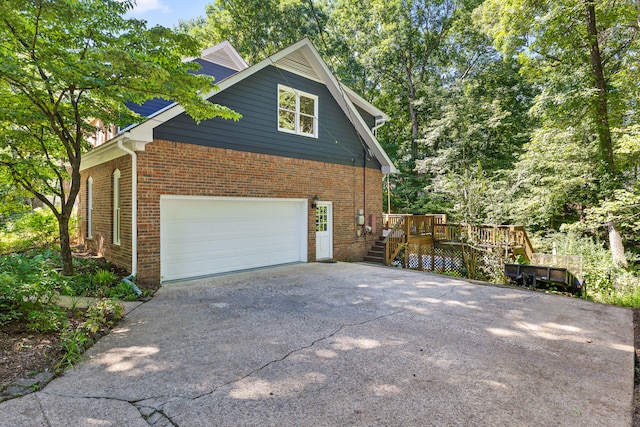 view of home's exterior featuring a garage and a deck