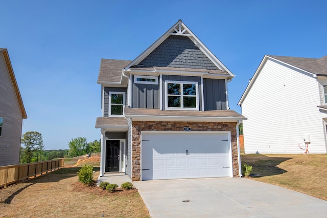 view of front of property with a front yard and a garage