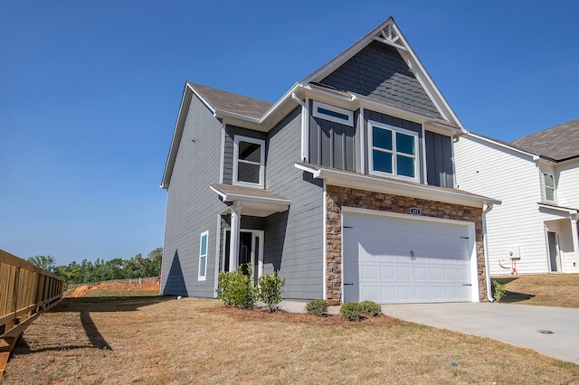 view of front of house with a front yard and a garage