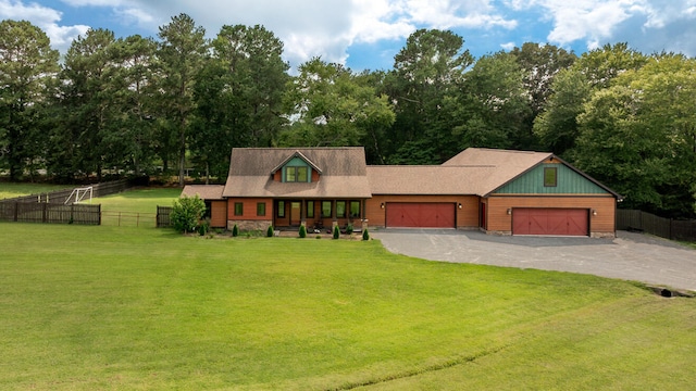 view of front of property with a garage and a front lawn