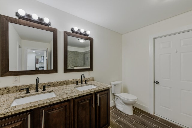 bathroom featuring vanity, toilet, and wood-type flooring