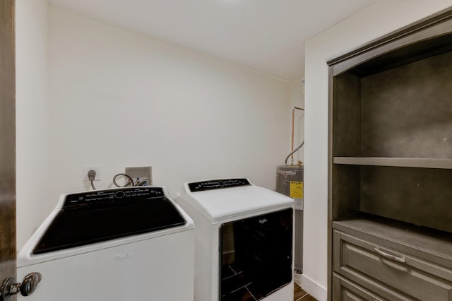 clothes washing area with hardwood / wood-style flooring and washing machine and dryer