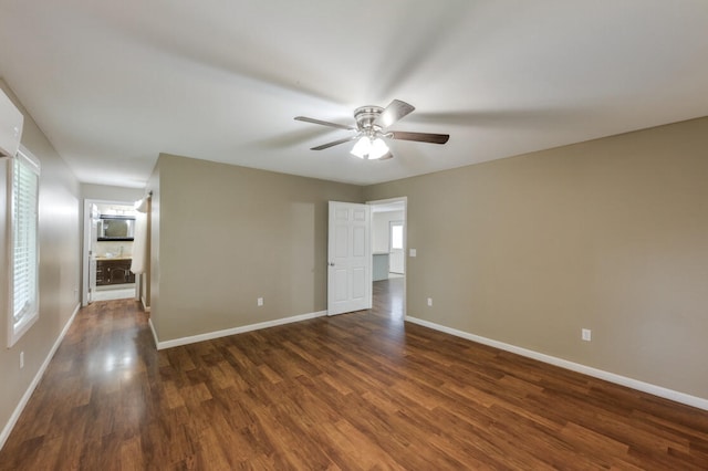 unfurnished room featuring ceiling fan and dark hardwood / wood-style flooring