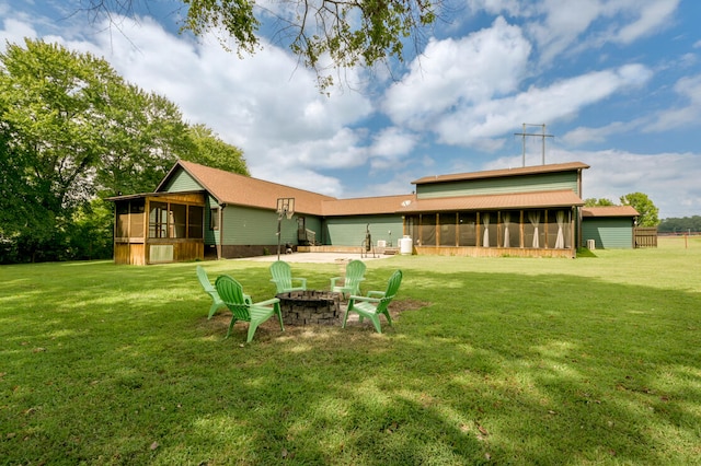 view of yard with a patio, a sunroom, and an outdoor fire pit