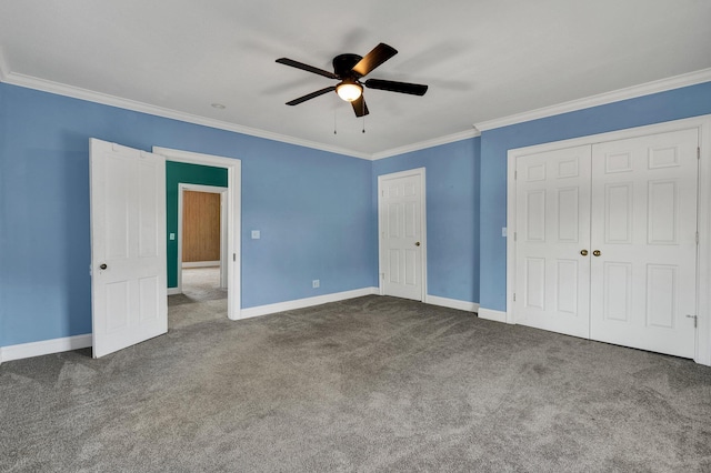 unfurnished bedroom with ceiling fan, crown molding, and dark colored carpet