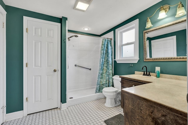 bathroom with tile patterned floors, vanity, toilet, and curtained shower