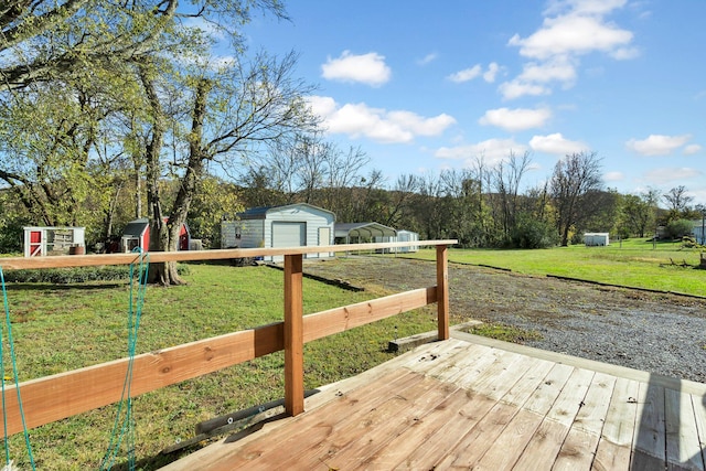 wooden deck with a lawn and a storage unit