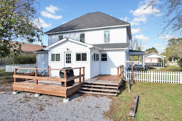 rear view of property with a deck and a yard