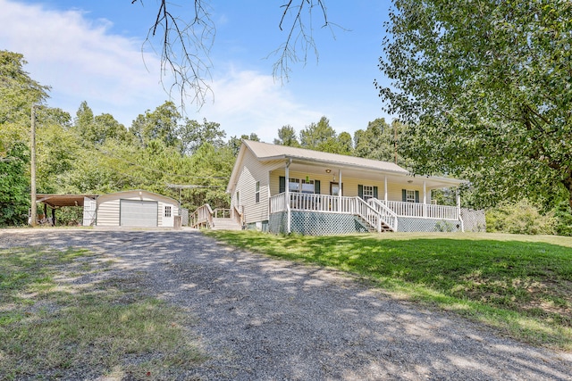 view of front of property with a front lawn, an outdoor structure, a garage, and a porch