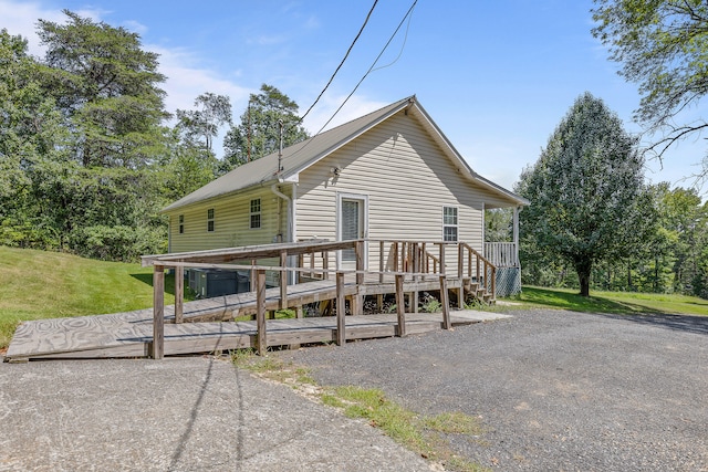 view of front facade with a front yard and a deck