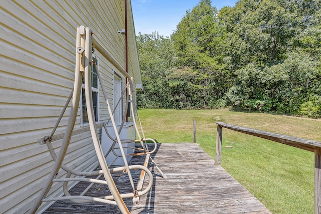 wooden deck featuring a lawn