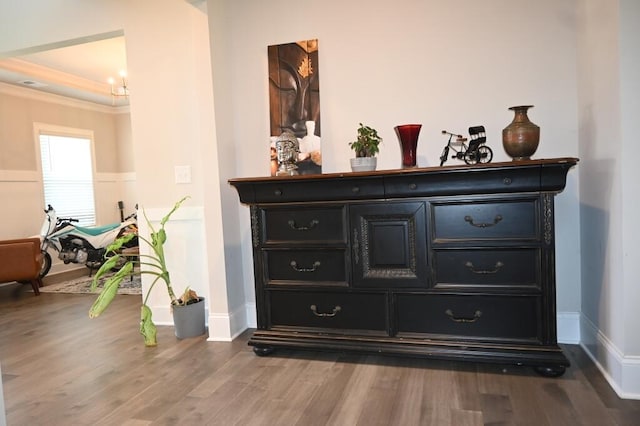 interior details with baseboards, ornamental molding, and wood finished floors
