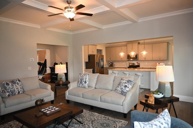 living area featuring coffered ceiling, a ceiling fan, wood finished floors, baseboards, and beamed ceiling