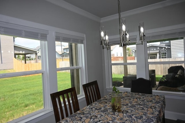 dining room with a healthy amount of sunlight and crown molding