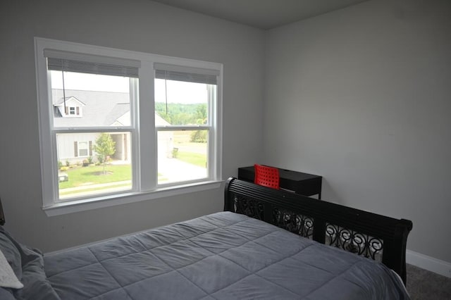 carpeted bedroom featuring baseboards