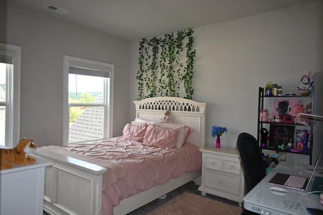 carpeted bedroom with visible vents