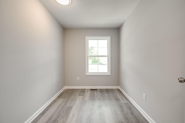 spare room with wood-type flooring