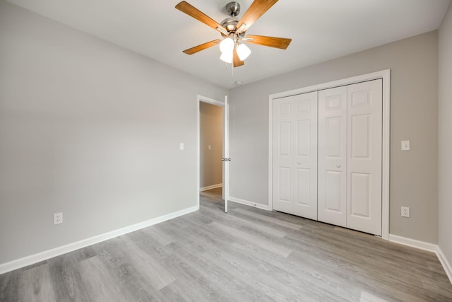 unfurnished bedroom with ceiling fan, a closet, and light hardwood / wood-style floors