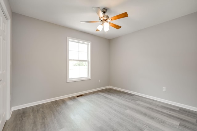 empty room featuring ceiling fan and hardwood / wood-style flooring