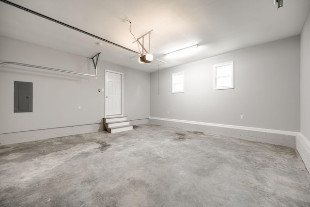 garage with electric panel and a garage door opener