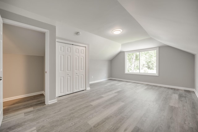 bonus room with lofted ceiling and light hardwood / wood-style flooring