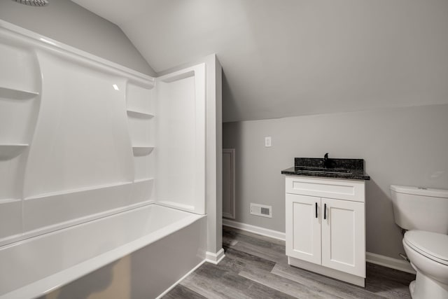 full bathroom with vanity, shower / washtub combination, hardwood / wood-style floors, toilet, and lofted ceiling