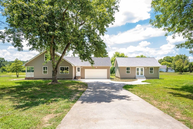 single story home featuring a front lawn and a garage