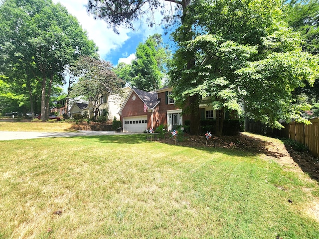 view of front of property featuring a front yard and a garage