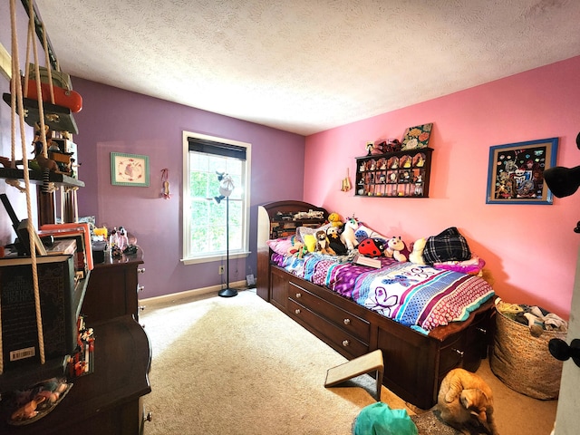 bedroom featuring light colored carpet and a textured ceiling