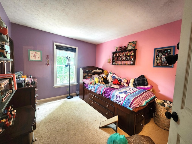 bedroom featuring light carpet and a textured ceiling