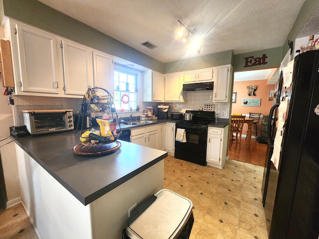 kitchen featuring white cabinetry, black appliances, and kitchen peninsula