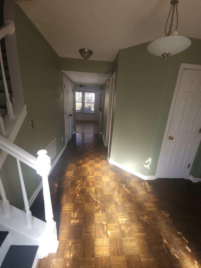 hallway with dark parquet flooring