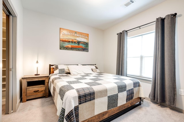 bedroom featuring multiple windows and light colored carpet